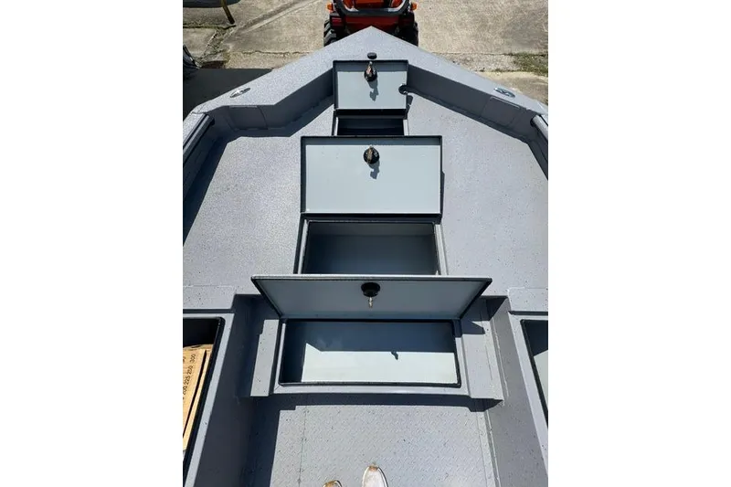 Slide: The Image of 2026 SeaArk Bay Runner 210 boat deck with open storage compartments. - 5