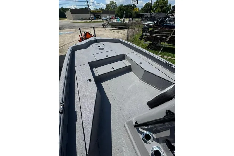 Slide: The Image of 2026 SeaArk Bay Runner 210 boat deck, featuring spacious seating and storage compartments. - 6