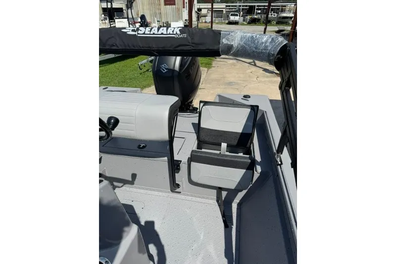 Slide: The Image of 2026 SeaArk Bay Runner 210 boat interior with seating and motor, showcasing modern design. - 8