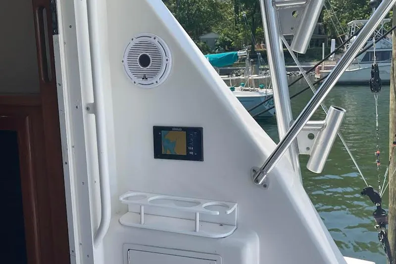 Slide: The Image of 1990 Viking 53 Convertible yacht interior with speaker, navigation screen, and rod holders. - 10