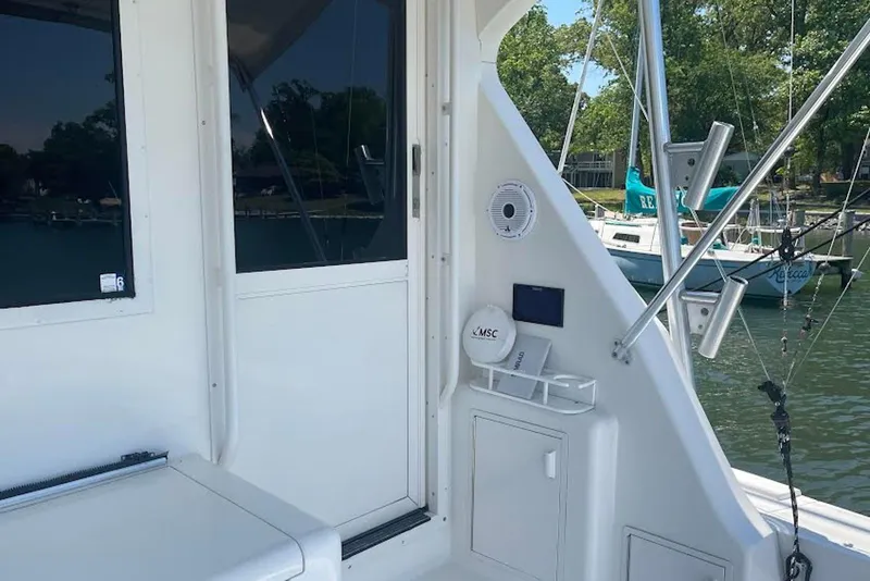 Slide: The Image of 1990 Viking 53 Convertible yacht deck with fishing rod holders and storage. - 11