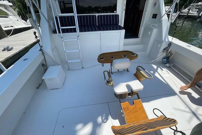 Slide: The Image of 1990 Viking 53 Convertible yacht deck with fishing chair and seating area. - 16