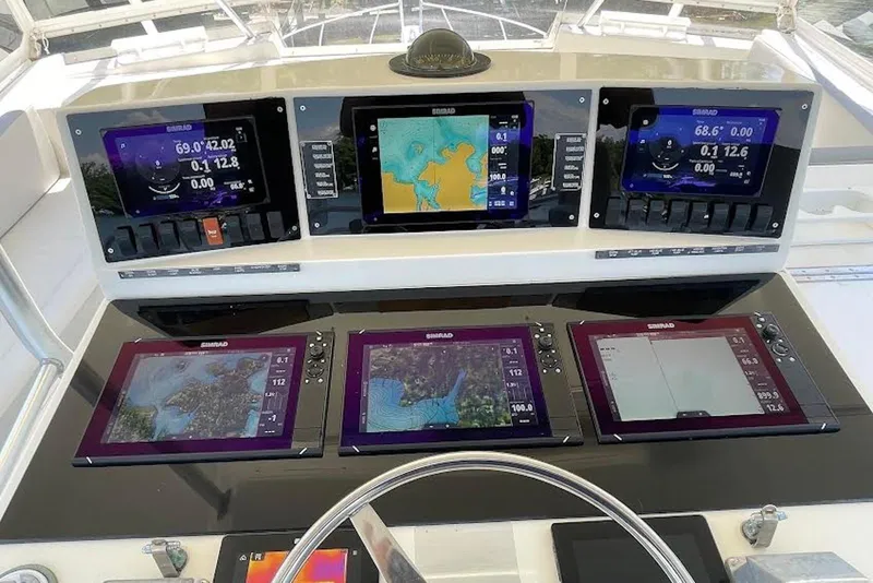 Slide: The Image of Control panel of a 1990 Viking 53 Convertible yacht with advanced navigation displays. - 20