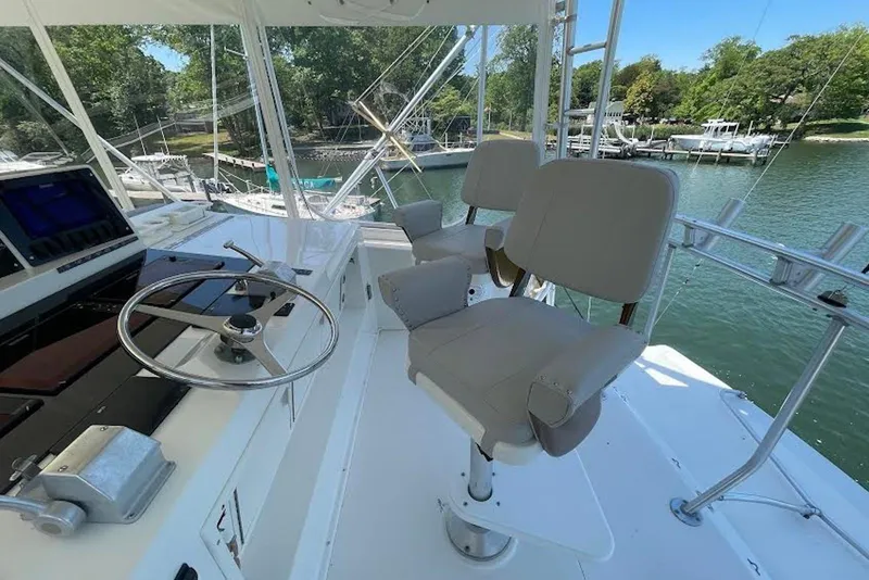 Slide: The Image of Helm of 1990 Viking 53 Convertible yacht with steering wheel and captain's chairs. - 21