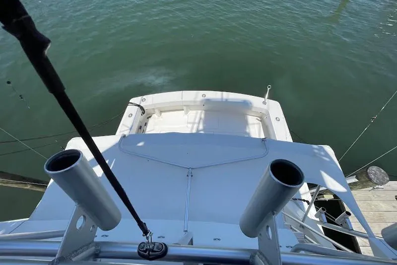 Slide: The Image of 1990 Viking 53 Convertible yacht, view from above, docked on calm water. - 23