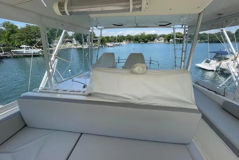 Slide: The Image of Interior view of a 1990 Viking 53 Convertible yacht overlooking a serene marina. - 27