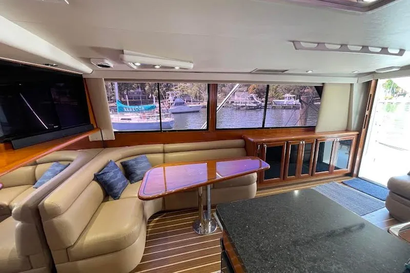 Slide: The Image of Luxurious interior of a 1990 Viking 53 Convertible yacht with elegant seating and large windows. - 28