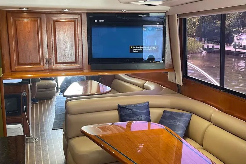 Slide: The Image of Luxurious interior of a 1990 Viking 53 Convertible yacht with leather seating and wood finishes. - 29