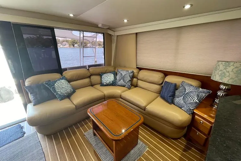 Slide: The Image of Luxurious interior of a 1990 Viking 53 Convertible yacht with plush seating and decorative pillows. - 30