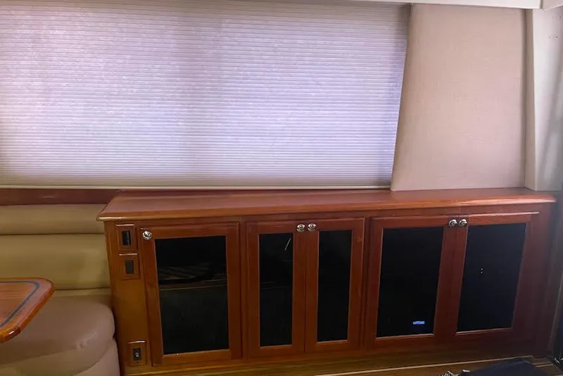 Slide: The Image of Interior of a 1990 Viking 53 Convertible yacht with wooden cabinetry and blinds. - 31