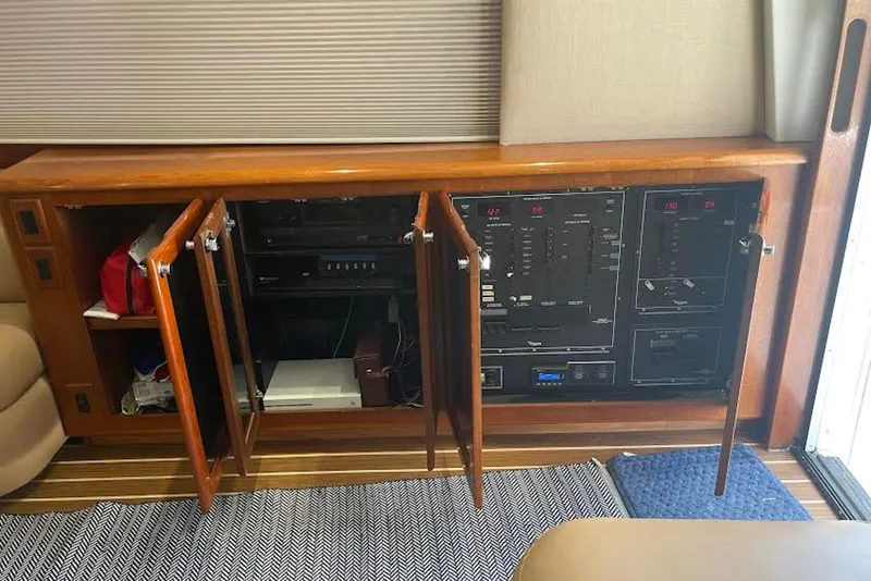 Slide: The Image of Electrical panel and storage in a 1990 Viking 53 Convertible yacht interior. - 32