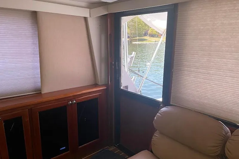 Slide: The Image of Interior of 1990 Viking 53 Convertible yacht with lake view through window. - 33