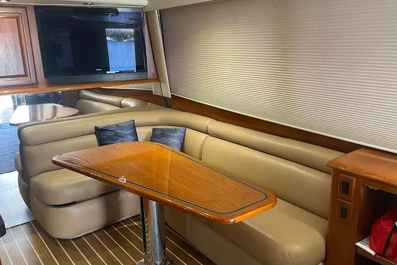 Slide: The Image of Interior of 1990 Viking 53 Convertible yacht with leather seating and wooden table. - 35