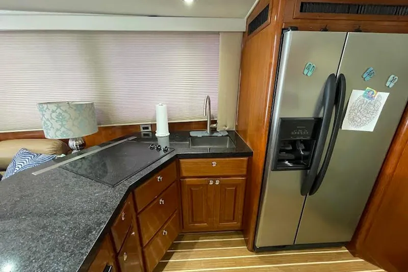 Slide: The Image of Luxurious kitchen interior of a 1990 Viking 53 Convertible yacht with modern appliances. - 36