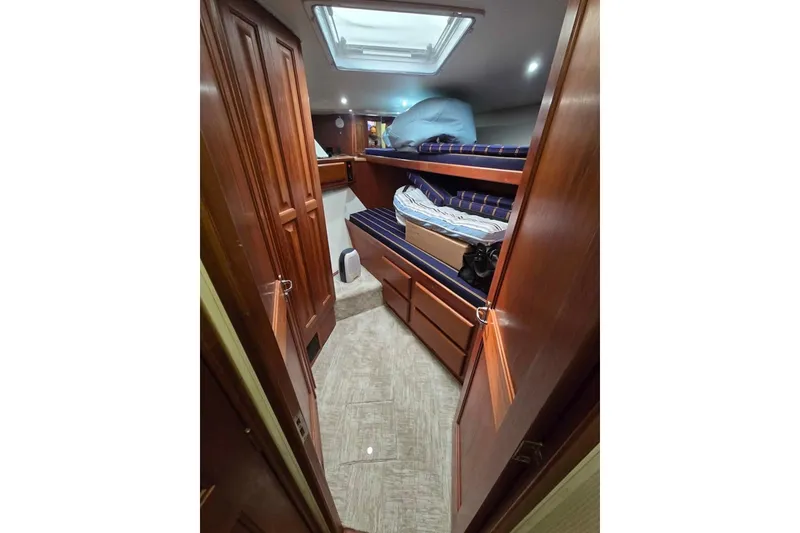 Slide: The Image of Interior cabin of 1990 Viking 53 Convertible yacht with wooden finishes and bunk beds. - 38