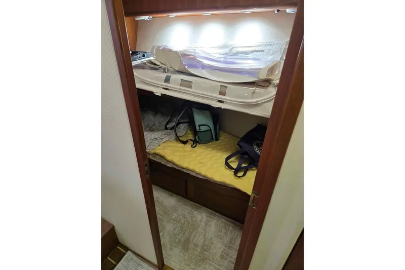 Slide: The Image of Cozy cabin interior of 1990 Viking 53 Convertible yacht with bunk beds and storage. - 39