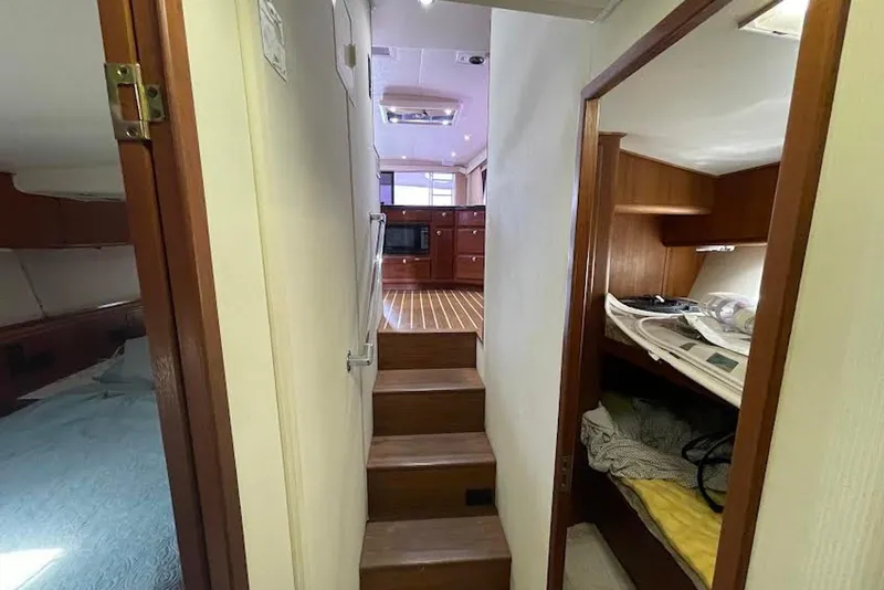 Slide: The Image of Interior of 1990 Viking 53 Convertible yacht with wooden stairs and cozy cabins. - 40