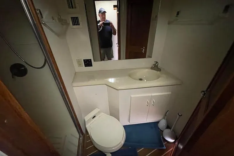 Slide: The Image of Bathroom interior of 1990 Viking 53 Convertible yacht with sink, toilet, and mirror. - 43