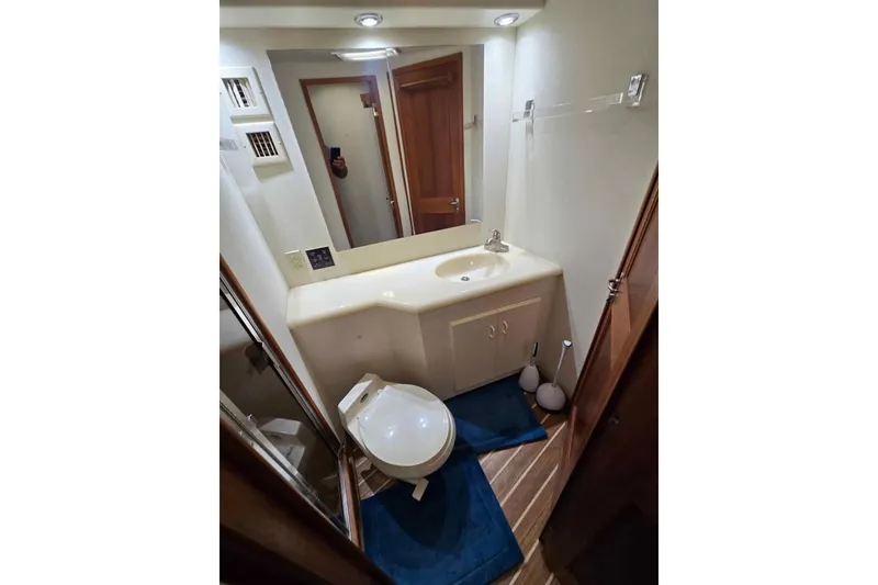 Slide: The Image of Bathroom interior of 1990 Viking 53 Convertible yacht with modern fixtures and wooden accents. - 46