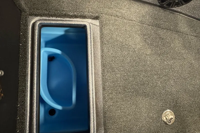 Slide: The Image of 2026 Nitro ZV19 Sport Pro boat storage compartment with blue interior and textured flooring. - 19