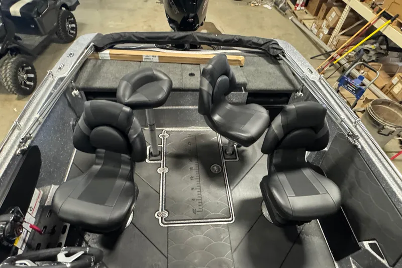 Slide: The Image of Interior of 2026 Nitro ZV19 Sport Pro boat with four black seats and storage compartments. - 21