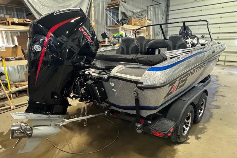 Slide: The Image of 2026 Nitro ZV19 Sport Pro boat with powerful Mercury engine in a garage setting. - 3