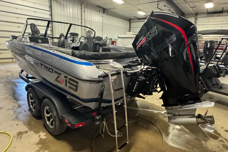 Slide: The Image of 2026 Nitro ZV19 Sport Pro boat with powerful engine in a garage setting. - 4