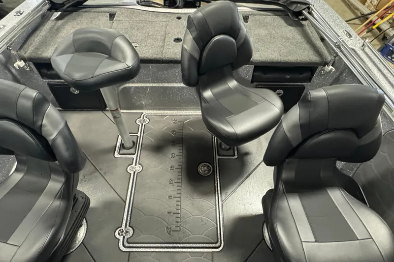 Slide: The Image of Interior of 2026 Nitro ZV19 Sport Pro boat with four black seats and measuring mat. - 9