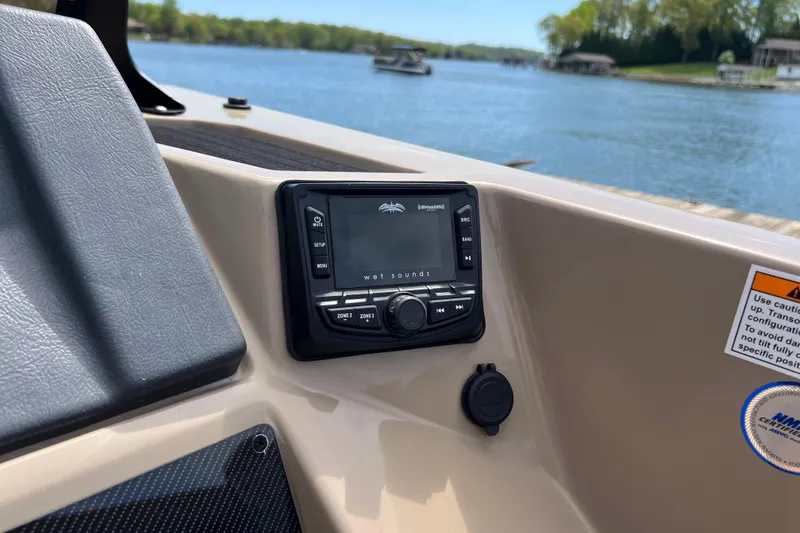 Slide: The Image of Control panel of 2026 Starcraft SLS 3 R boat with lake view in background. - 11