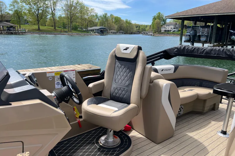 Slide: The Image of Luxurious 2026 Starcraft SLS 3 R boat interior with plush seating by a serene lake. - 13