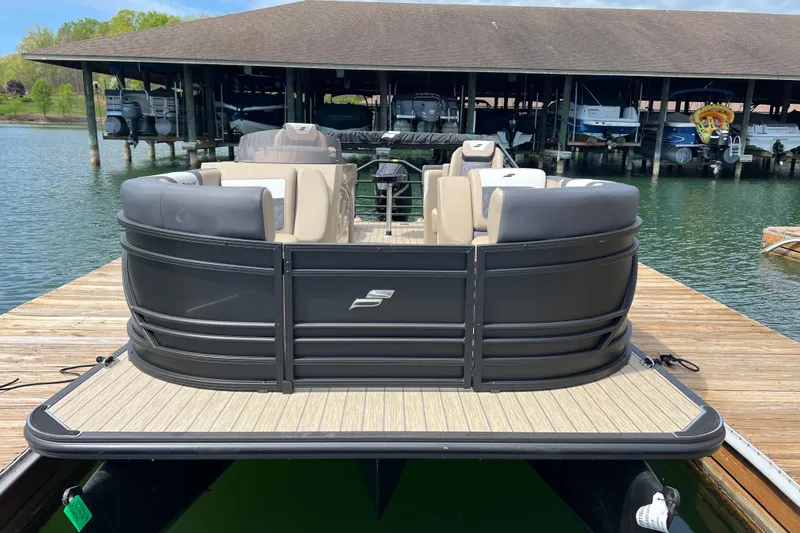Slide: The Image of 2026 Starcraft SLS 3 R pontoon boat docked on a sunny day. - 2