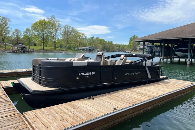 Slide: The Image of 2026 Starcraft SLS 3 R pontoon boat docked on a serene lake. - 3