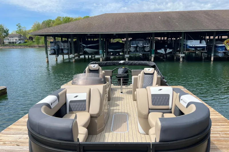 Slide: The Image of 2026 Starcraft SLS 3 R pontoon boat docked, featuring luxurious seating and spacious deck. - 5