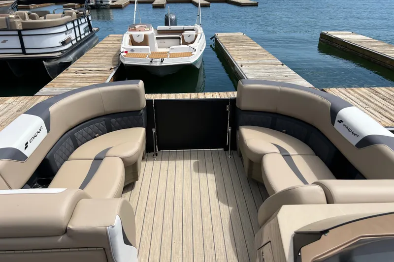 Slide: The Image of Luxurious 2026 Starcraft SLS 3 R pontoon boat interior at marina dock. - 6