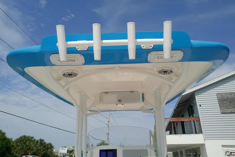 Slide: The Image of 2022 Glasstream 280 Pro-XS boat top view with rod holders and speakers under blue sky. - 11
