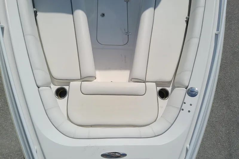 Slide: The Image of 2022 Glasstream 280 Pro-XS boat interior with white cushioned seating and cup holders. - 21