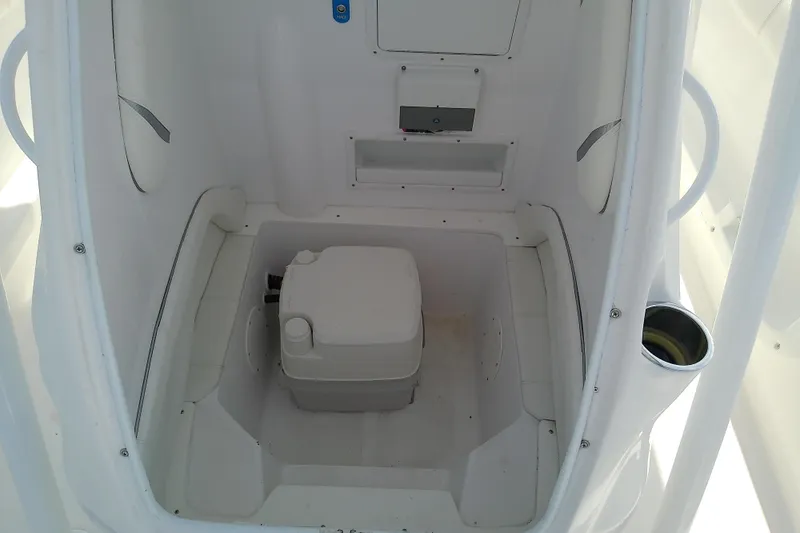 Slide: The Image of 2022 Glasstream 280 Pro-XS boat interior with compact marine toilet. - 28