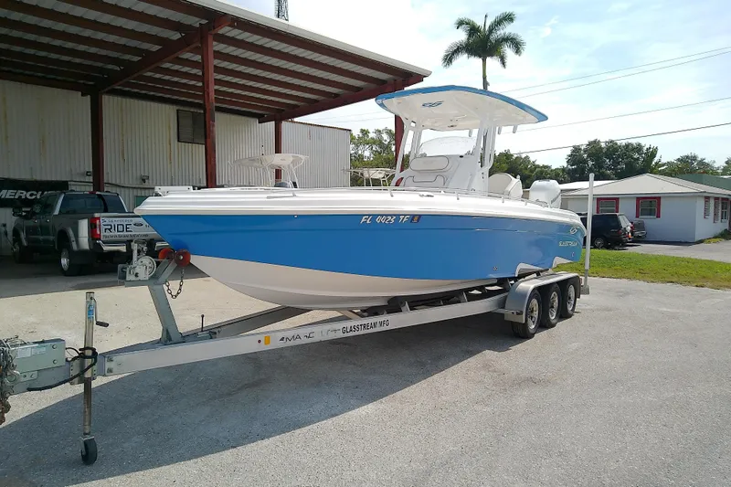 Slide: The Image of 2022 Glasstream 280 Pro-XS boat on trailer, parked outdoors near a building. - 3