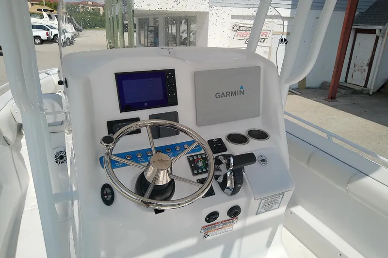 Slide: The Image of 2022 Glasstream 280 Pro-XS boat dashboard with Garmin navigation system and steering wheel. - 30