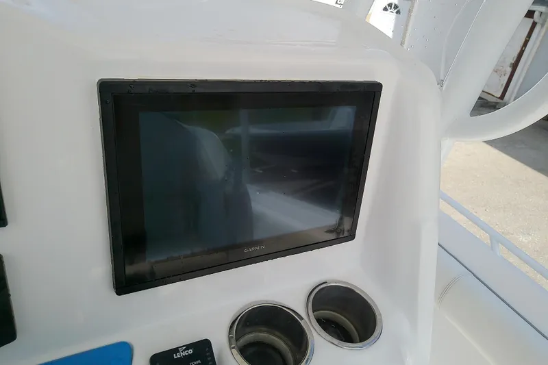 Slide: The Image of Garmin display on 2022 Glasstream 280 Pro-XS boat dashboard with cup holders. - 32