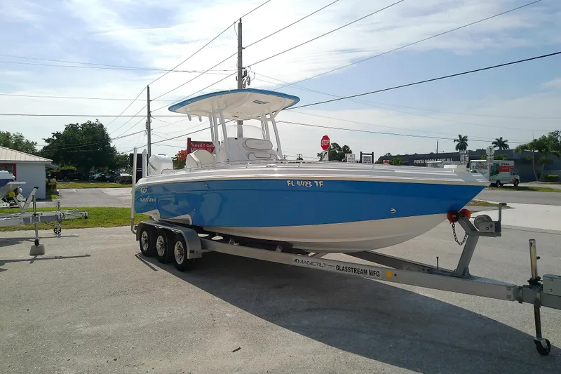 Slide: The Image of 2022 Glasstream 280 Pro-XS boat on trailer, parked outdoors under clear sky. - 4