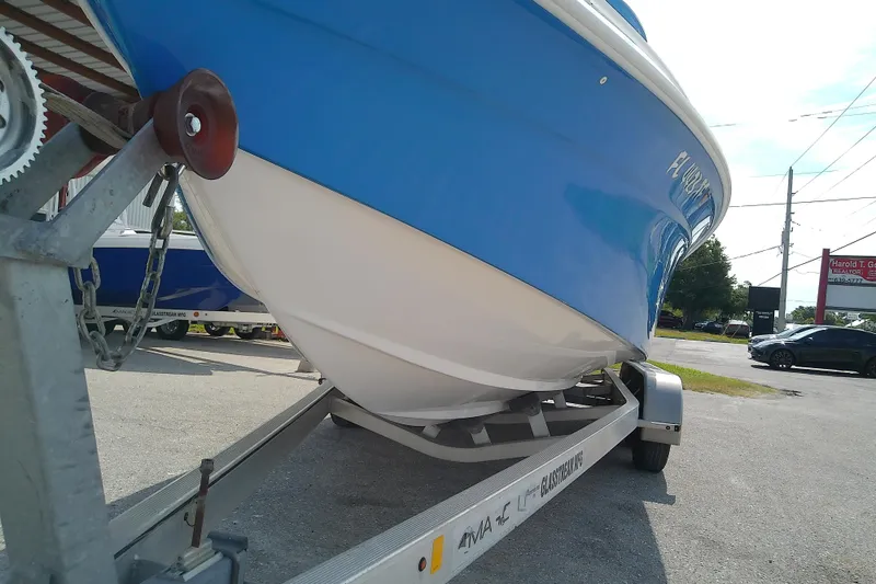 Slide: The Image of 2022 Glasstream 280 Pro-XS boat on trailer, blue and white hull, outdoor setting. - 9