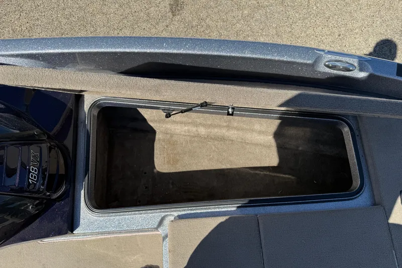 Slide: The Image of Open storage compartment on a 2009 Ranger 188 VX boat, showing interior space. - 11