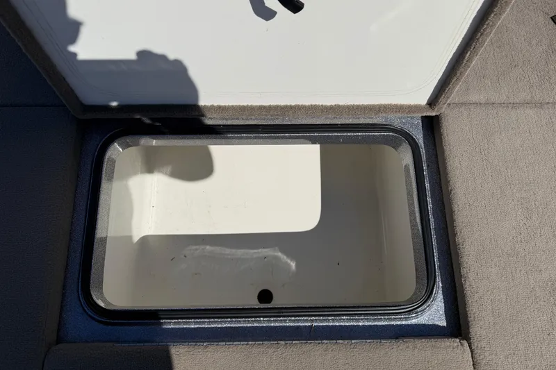Slide: The Image of Open storage compartment in 2009 Ranger 188 VX boat, showing interior space. - 12