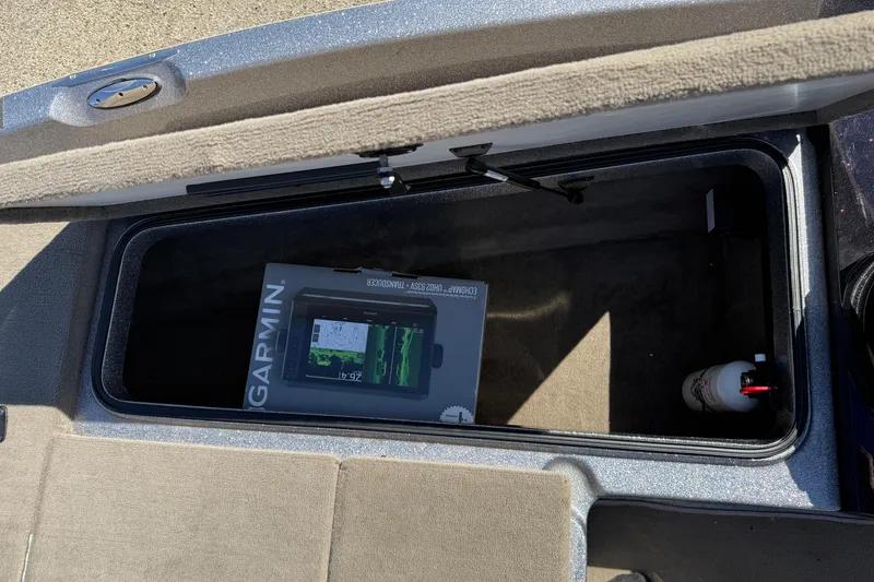 Slide: The Image of Open storage compartment in 2009 Ranger 188 VX boat with Garmin device box inside. - 13