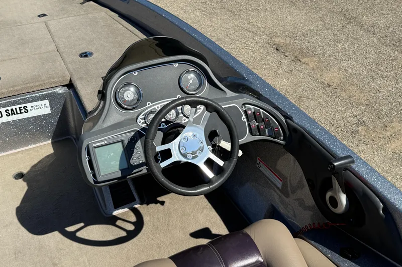 Slide: The Image of 2009 Ranger 188 VX boat dashboard with steering wheel and control panel. - 19