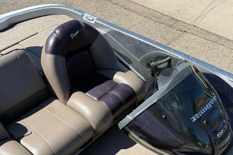 Slide: The Image of 2009 Ranger 188 VX boat interior with steering console and cushioned seats. - 20