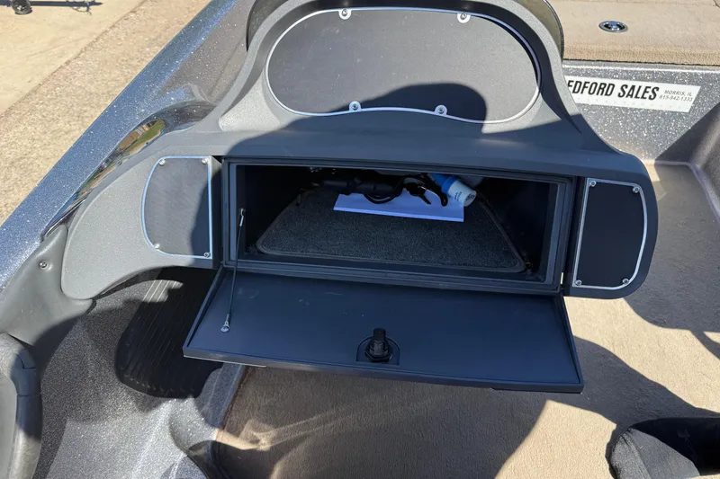 Slide: The Image of Open storage compartment in a 2009 Ranger 188 VX boat, showing interior details. - 23