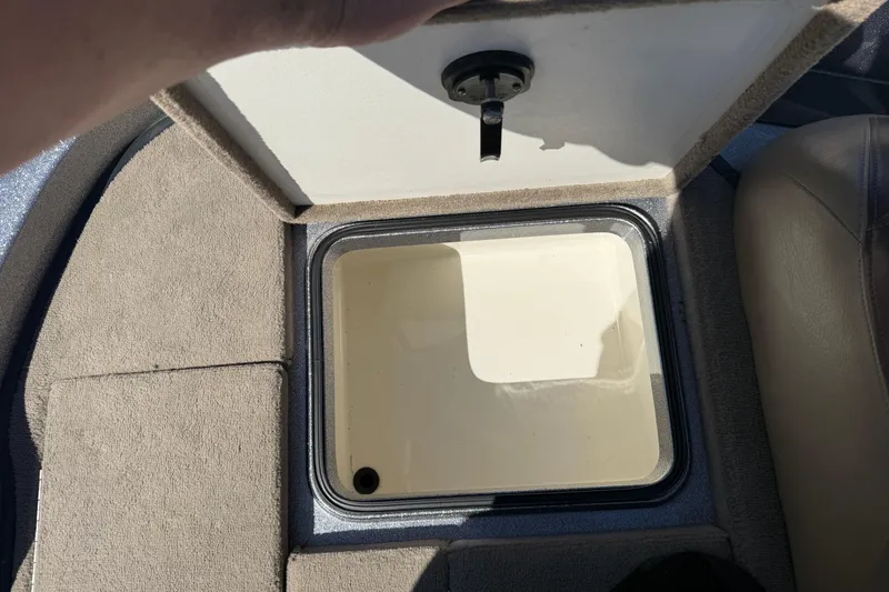 Slide: The Image of Open storage compartment in a 2009 Ranger 188 VX boat, showing interior details. - 25