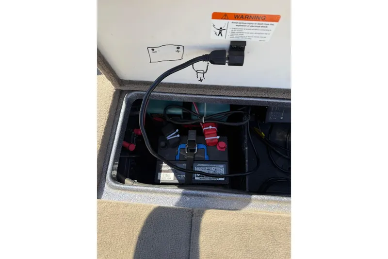 Slide: The Image of Battery compartment of a 2009 Ranger 188 VX boat with wiring and warning label. - 30